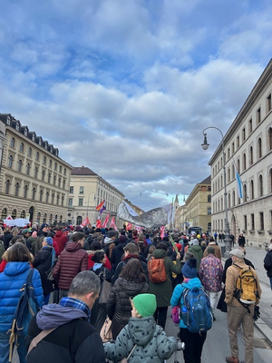 Die Fotos zeigen Teilnehmerinnen und Teilnehmer der Mieten-Demo in München. Man sieht, wie die Demonstrierenden auf der Straße unterwegs sind und Fahnen und Transparente hochhalten.